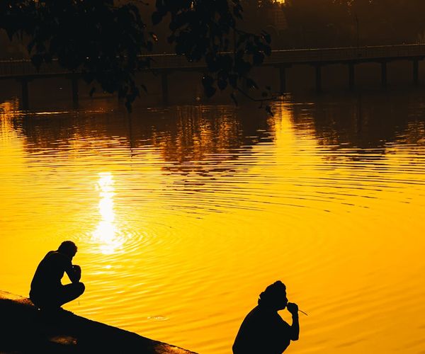Silhouette of a person meditating in a peaceful office environment.